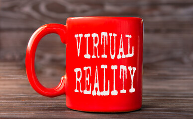 VIRTUAL REALITY - words on a red cup on a dark background.