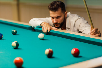 Billiard player at billard table or snooker american billiards pool sport game