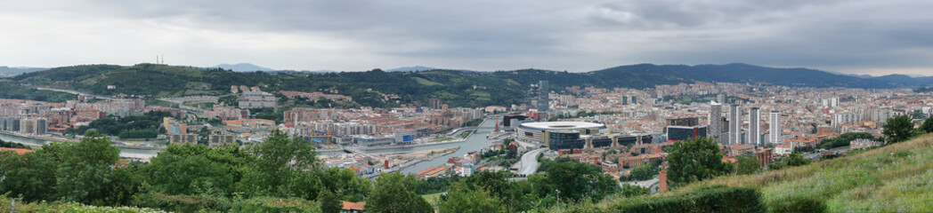 Fototapeta na wymiar Panoramic aerial exterior view at the Bilbao downtown city, Nervion river and iconic buildings