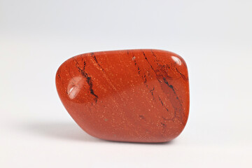 Jasper is one of the many gemstone varieties of quartz,  Red color is due to iron inclusions.