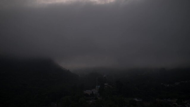 Hyperlapse approaching landscape with mountains in Teresopolis, Rio de Janeiro, Brazil with the iconic Dedo de Deus or Finger of God covered by clouds