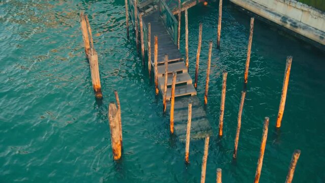 Moving poles in Venice waterways dock and canals with calm waves
