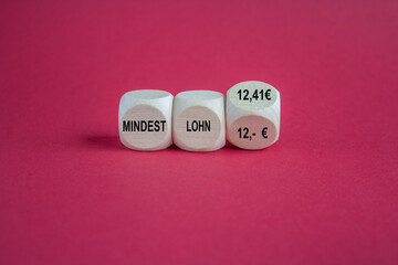 Symbol for the increase of the minimum wage Mindestlohn in Germany from 12 Euro to 12.41 Euro in January 2024. Beautiful red background.