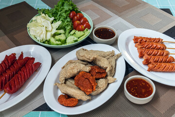 The fried meatballs made from a variety of meats and sausages, mixed with flour and seasonings with a delicious spicy sauce and come with cucumber, cabbage, tomato and lettuce as sides. Street Food.