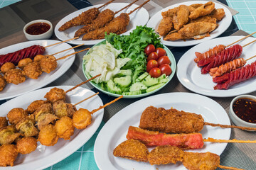 The fried meatballs made from a variety of meats and sausages, mixed with flour and seasonings with a delicious spicy sauce and come with cucumber, cabbage, tomato and lettuce as sides. Street Food.