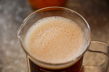 High angle view of the cold black tea with tiny bubbles on the surface. Food and drink.