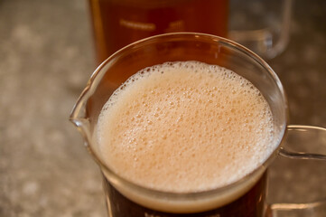 High angle view of the cold black tea with tiny bubbles on the surface. Food and drink.