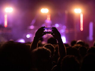 Crowd with phones at concert.