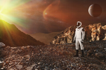 Spaceman walks on the alien planet. Space Mission. Elements of this image furnished by NASA.