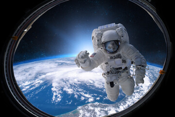 Astronaut in outer space from porthole on background of the Eart - obrazy, fototapety, plakaty