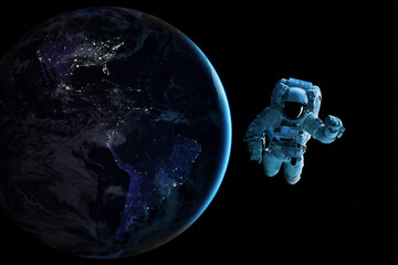 Fototapeta na wymiar Cosmonaut is flying in outer space on night Earth planet background. Elements of this image furnished by NASA.