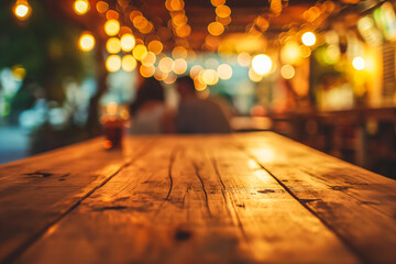 A wooden table perspective at a night market with warm bokeh lights and a blurred couple in the background - obrazy, fototapety, plakaty