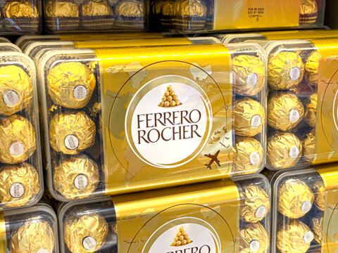Roma, Italy, 20 December 2023:  Ferrero Rocher  on a shelf in a store in the Duty Free store at Rome Fiumicino Airport. Is a spherical chocolate produced by the Italian chocolatier Ferrero SpA.
