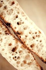 Extremely close up photo of two halves of fresh, delicious ross-section of French bread, baguette perfectly prepared. Concept of cooking, food, traditions and innovations, nutrition, recipes.
