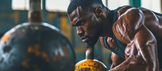 Black man uses kettlebell for rigorous fitness training, focusing on sports exercise, muscle...