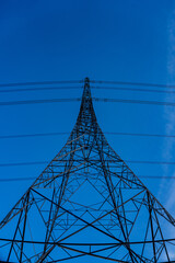 Electricity Pylon against a winter blue sky in Scotland