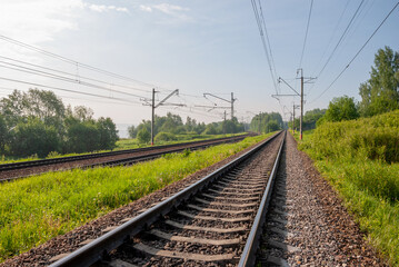 Railway against a beautiful colorful sky at sunset. Industrial landscape with railroad, blue sky...