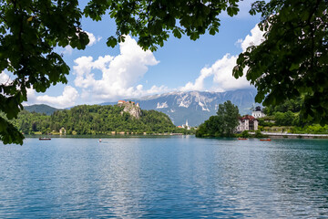 Scenic view of majestic medieval castle at Lake Bled nestled amidst lush forest in Upper Carniola,...