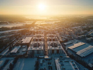 sunny winter over arctic town, sunset and snow at european city suburb residential district, snowfall at europe aerial