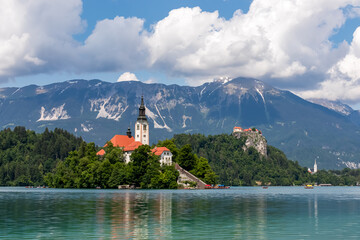 Scenic view of St Mary Church and medieval castle at Lake Bled, Upper Carniola, Slovenia. Viewing platform. Water reflection of serene landscape in remote nature in Julian Alps and Karawanks in summer