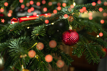 Close up of xmas balls on Christmas tree. Bokeh garlands in the background. New Year concept. High quality photo