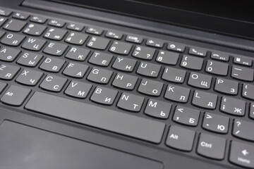 A beautiful stylish black 14 inch laptop with a simplified, miniature, slim keyboard with no calculator keys.