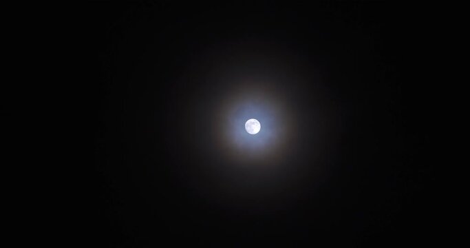 a circular rainbow forming around the moon, real time shot speed
