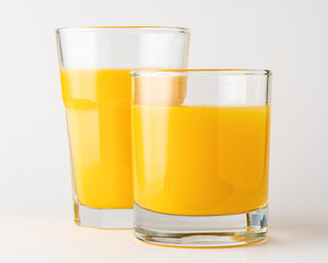 Two glasses of orange juice on white background. Fruit concept.