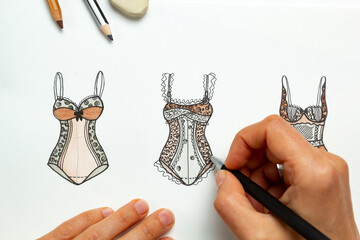 The designer draws sketches of women's underwear.