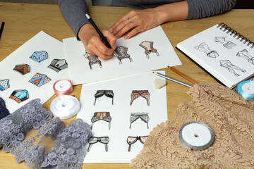 The designer draws sketches of women's underwear.