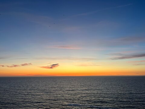 Ocean and purple sky at the ocean bay, orange ocean horizon