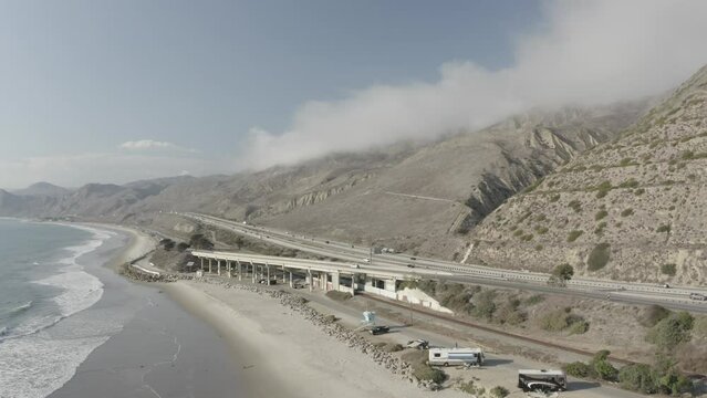 Pacific Coast Highway with Mountains, Clouds and Waves (aerial)
