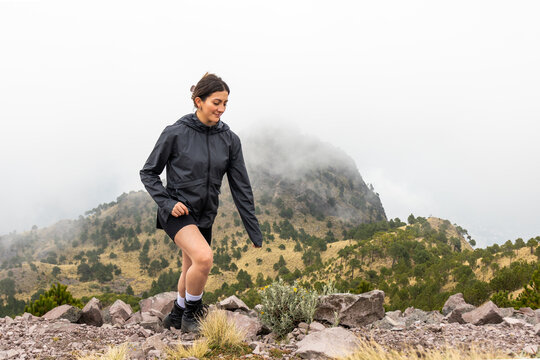 Woman walking in mountainous terrain in Cumbres del Ajusco National Park