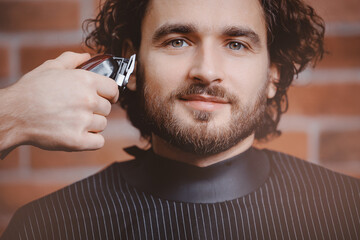 Portrait Man in barber chair hairdresser styling his hair. Barbershop banner background