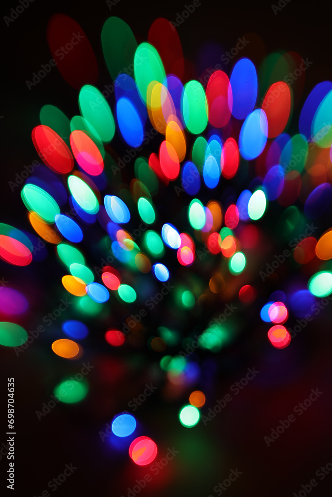Poster a pattern of festive bokeh lights on a black background