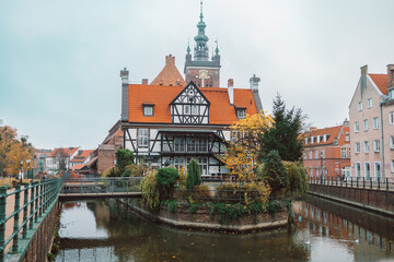 View from the front of the Millers' Guild house and the Radunia Canal in Gdansk, Poland on a blue sky summer day. High quality photo