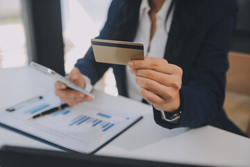 Women holding credit card and using smartphones at home.Online shopping, internet banking, store...