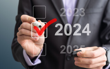Businessman pressing virtual button New 2024 Year