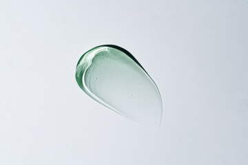 Aloe Vera Gel transparent, slightly green tinted smear against a white background