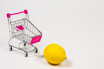Lemon in shopping cart on white background