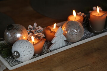 Table Christmas decoration with lit candles, warm light