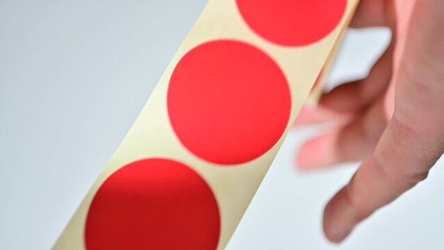 Opening barcode roll labels by hand. Opened thermal barcode roll.	