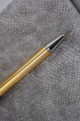 Very stylish, luxurious, velvet, grey notebook, business diary, book with golden stylish pen and...