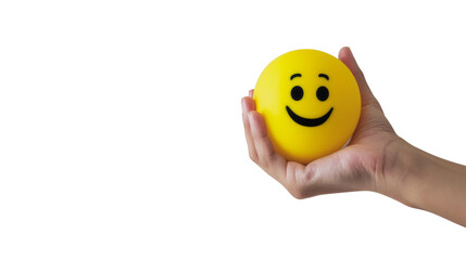 Hand holding a smiley face stress ball against a transparent background, conveying positivity and stress relief.