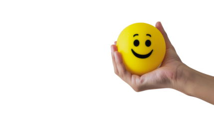 Hand holding a smiley face stress ball against a transparent background, conveying positivity and stress relief.