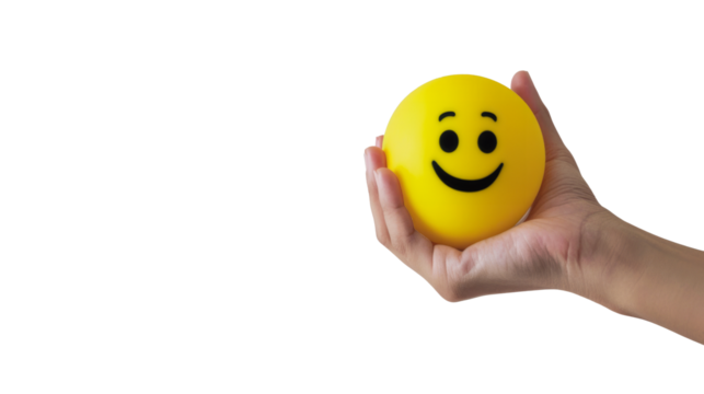 Hand holding a smiley face stress ball against a transparent background, conveying positivity and stress relief.