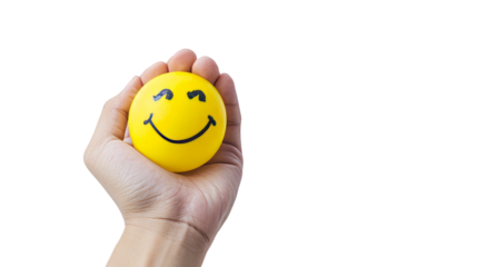 Hand holding a smiley face stress ball against a transparent background, conveying positivity and stress relief.