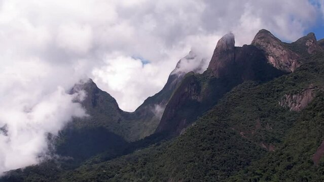 Hyperlapse approaching landscape with mountains in Teresopolis, Rio de Janeiro, Brazil with the iconic Dedo de Deus or Finger of God covered by clouds