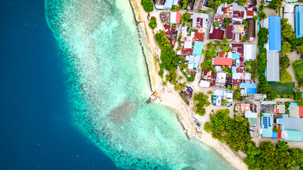 Closeup Drone Aerial View Looking Down on Island Beach Town in the Mediterranean with Crystal Clear...