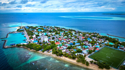 Drone Aerial View of Mahibadhoo an island town in central Maldives  - obrazy, fototapety, plakaty